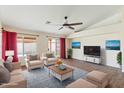Bright living room boasting neutral furniture, large windows, and backyard access at 1061 E Linda Ln, Gilbert, AZ 85234