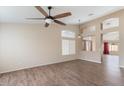 Spacious living room features wood-look tile flooring, a ceiling fan, and an open layout at 1061 E Linda Ln, Gilbert, AZ 85234