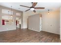 Bright living room features wood-look tile flooring, a ceiling fan, and neutral paint at 1061 E Linda Ln, Gilbert, AZ 85234
