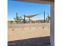View from the home includes a shaded playground with desert landscaping at 10612 W Sonrisas St, Tolleson, AZ 85353