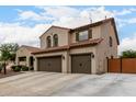 Charming two-story home featuring a three car garage and spacious driveway with a red tile roof at 12300 N 142Nd Ln, Surprise, AZ 85379