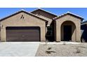 Exterior of the home features a neutral color scheme and a two-car garage at 13226 E Verbina Ln, Florence, AZ 85132