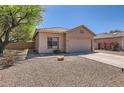 Inviting single-story home with low-maintenance landscaping and a two-car garage at 13337 W Evans Dr, Surprise, AZ 85379