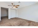 Spacious living room featuring soft carpeting, a ceiling fan, and ample space at 13337 W Evans Dr, Surprise, AZ 85379