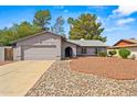Well-kept house with two car garage, desert landscaping, and a cozy, inviting front entrance in a quiet neighborhood at 16412 N 33Rd Ave, Phoenix, AZ 85053