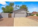 Exterior view showing front yard landscaping, attached two-car garage, and neutral stucco finish in a suburban neighborhood at 16412 N 33Rd Ave, Phoenix, AZ 85053