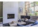 Elegant living space with a fireplace, a sleek piano, and bright windows, perfect for relaxation at 1701 E Colter St # 264, Phoenix, AZ 85016