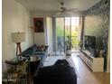 Cozy living room features a ceiling fan and sliding glass doors opening to the outside at 1701 E Colter St # 264, Phoenix, AZ 85016