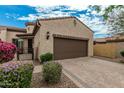 Inviting home exterior with desert landscaping and a paved driveway leading to a two-car garage at 1813 N Trowbridge --, Mesa, AZ 85207