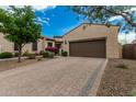 Inviting home with lush landscaping and a paved driveway leading to a two-car garage at 1813 N Trowbridge --, Mesa, AZ 85207