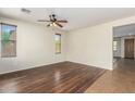 Bright living room with stylish ceiling fan and multiple windows at 1867 S Seton Ave, Gilbert, AZ 85295