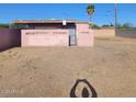 Exterior view of a home with a gravel backyard and a view of the building structure at 1916 N 22Nd St, Phoenix, AZ 85006