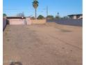Spacious vacant lot surrounded by walls and a mature palm tree, ready for construction or landscaping at 1916 N 22Nd St, Phoenix, AZ 85006