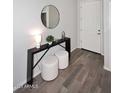 Bright entryway featuring stylish console table with stools and a decorative mirror at 2425 E Beverly Rd, Phoenix, AZ 85042