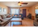 Relaxing living room featuring tile floors, cozy sofas, and a ceiling fan, providing a comfortable atmosphere at 2534 N Mitchell St. St, Phoenix, AZ 85006