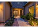 Charming front porch of a home featuring stone accents, desert landscaping and a cozy seating area at 30224 N 52Nd Pl, Cave Creek, AZ 85331
