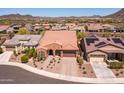 An aerial shot of a landscaped house featuring a tile roof, desert landscaping, and a two-car garage at 30876 N 128Th Dr, Peoria, AZ 85383