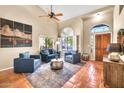 Bright living room featuring high ceilings, terracotta floors and comfortable blue seating at 3854 E Cathedral Rock Dr, Phoenix, AZ 85044