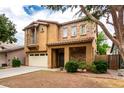 Inviting two-story home featuring a stone facade, balcony, well-maintained landscaping and a two car garage at 4368 E Cullumber St, Gilbert, AZ 85234