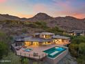 Luxury home showcasing a pool and spa, with outdoor seating and scenic mountain views at 4536 E Foothill Dr, Paradise Valley, AZ 85253