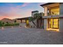 Elegant home entrance featuring a paved driveway, desert landscaping, and modern architectural details at 4536 E Foothill Dr, Paradise Valley, AZ 85253