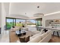 Bright living room with large windows showcasing mountain views and an open layout with a stylish bar area at 4536 E Foothill Dr, Paradise Valley, AZ 85253