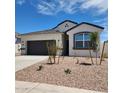 Charming single-story home featuring a gray garage door, neutral stucco and simple desert landscaping at 4939 S 106Th Ave, Tolleson, AZ 85353