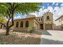Inviting two-story home with a landscaped front yard and attached two-car garage at 5425 W Harwell Rd, Laveen, AZ 85339