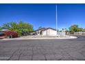 Street view of a single-story stucco home with desert landscaping and a clear blue sky at 646 W Grove Cir, Mesa, AZ 85210