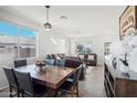Open-concept floorplan, with dining area, and bright living room with large windows at 6836 W Bronco Trl, Peoria, AZ 85383