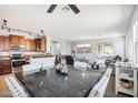 Open floorplan featuring a kitchen, dining area, and living room at 6836 W Bronco Trl, Peoria, AZ 85383