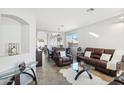 Inviting living room with tile floors, leather seating, and natural light at 6836 W Bronco Trl, Peoria, AZ 85383