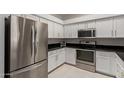Modern kitchen with stainless steel appliances, white cabinets, and black countertops at 7006 E Jensen St # 40, Mesa, AZ 85207