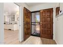 Inviting foyer with wooden floors, a decorative front door, and a glimpse into the bright kitchen at 7315 E Arlington Rd, Scottsdale, AZ 85250
