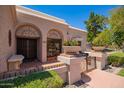 Charming home entrance with decorative ironwork, terracotta tiles, and beautiful potted plants, offering curb appeal at 7315 E Arlington Rd, Scottsdale, AZ 85250