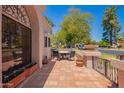 Outdoor patio area features terracotta tiles, wrought iron railings, and comfortable seating for relaxation and entertainment at 7315 E Arlington Rd, Scottsdale, AZ 85250