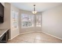Cozy dining area with a bay window overlooking the back yard, complete with decorative lighting at 7709 W Tonto Dr, Glendale, AZ 85308