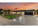 Well-maintained single-story home with a spacious driveway, charming porch, and manicured front yard at 8419 E Rancho Vista Dr, Scottsdale, AZ 85251