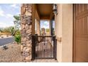 Charming gated patio with stone accents and a view of the surrounding community at 8804 E Ivy St, Mesa, AZ 85207