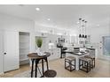 Modern kitchen with white cabinets, stainless steel appliances, and a breakfast bar at 9110 W Palm Ln, Phoenix, AZ 85037