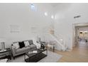 Bright living room with high ceilings and a cozy seating area with modern decor at 9110 W Palm Ln, Phoenix, AZ 85037