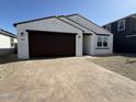 Inviting single-story home with a brick-paved driveway leading to the attached two-car garage at 9547 W Parkway Dr, Tolleson, AZ 85353