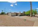 Charming single-story home boasts a well-maintained front yard with mature landscaping and a two-car garage at 10429 W Oakmont Dr, Sun City, AZ 85351