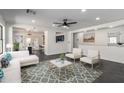 Airy living room with open layout, modern decor, and view to dining area and kitchen at 11359 E Elena Ave, Mesa, AZ 85208
