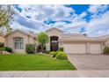 Charming single-story home boasts a well-manicured lawn, mature trees, and a three-car garage at 11651 E Appaloosa Pl, Scottsdale, AZ 85259