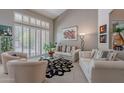 Bright living room featuring vaulted ceilings, plantation shutters, neutral decor and large windows at 11651 E Appaloosa Pl, Scottsdale, AZ 85259