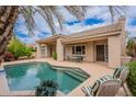 Inviting backyard oasis features a sparkling pool, patio seating, and lush landscaping for outdoor relaxation at 11651 E Appaloosa Pl, Scottsdale, AZ 85259