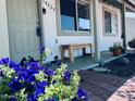 Inviting front porch with lovely flowers and a wooden bench at 14439 N 38Th Pl, Phoenix, AZ 85032