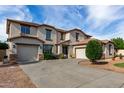 Stately two-story home with a three-car garage and meticulously landscaped front yard offers great curb appeal at 15028 W Minnezona Ave, Goodyear, AZ 85395