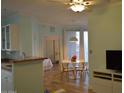 Open-concept dining room featuring a modern ceiling fan and table adjacent to the kitchen at 1701 E Colter St # 280, Phoenix, AZ 85016